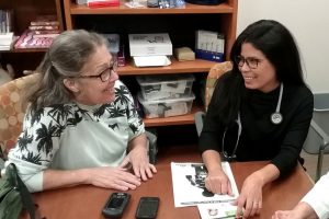 Diabetes patient speaking with some of her care team in a conference room