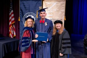 CEIN/BS graduate Brent Mayerson '24 (NUR) receiving his diploma