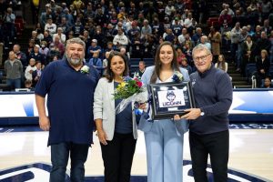 Gabi Mendonca poses with her family and UConn coach Geno Auriemma at Senior Night.