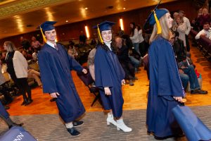 BS/CEIN graduates Kaeleigh and Logan Broyles walking up the aisle for graduation