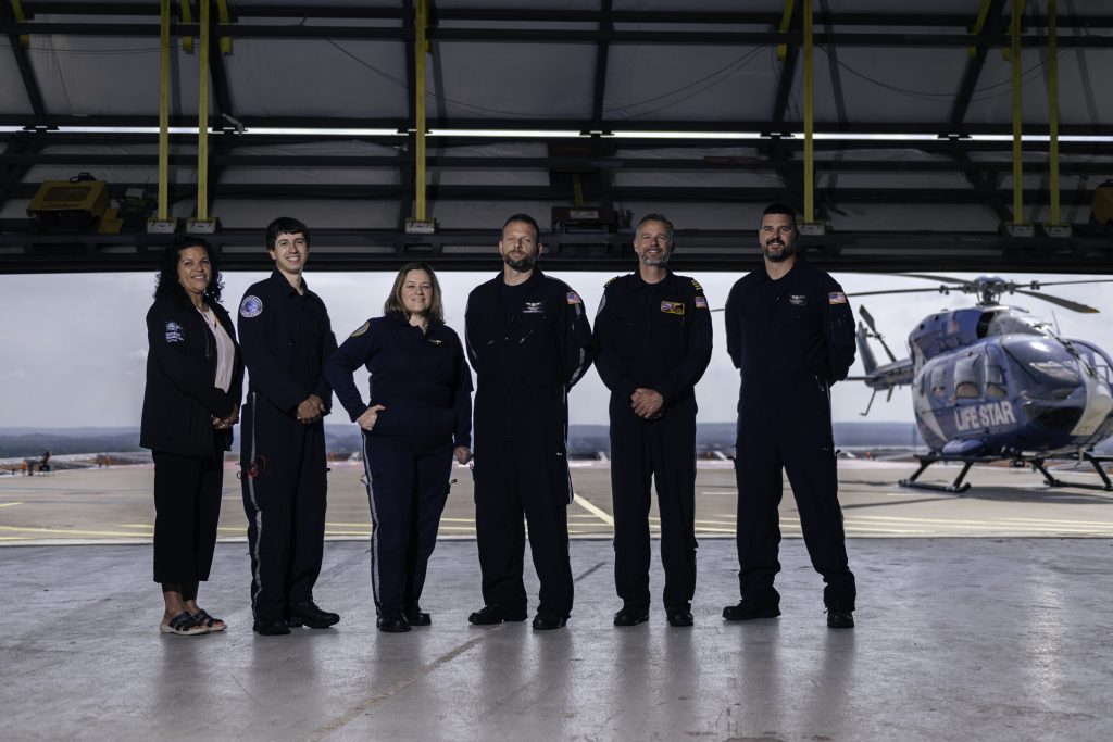 Members of the LIFE STAR crew gather on the thirteenth floor of Hartford Hospital prior to an emergency call. From left: Janet Diaz, senior administrative associate; Justin Pedneault, flight nurse/paramedic; alumna Patricia Margarido '19 EMBA, LIFE STAR Program Director; Brendon Colt, flight paramedic/base lead; Bob Lynch, pilot and Adam Dawidczyk, flight nurse.