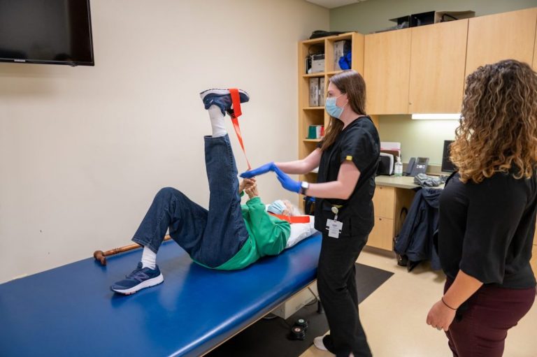 Evelyn Reuter performs exercises as part of a UConn Center on Aging Study under the supervision of research associate Kylie Baker (center) and Jenna Bartley Ph.D (right