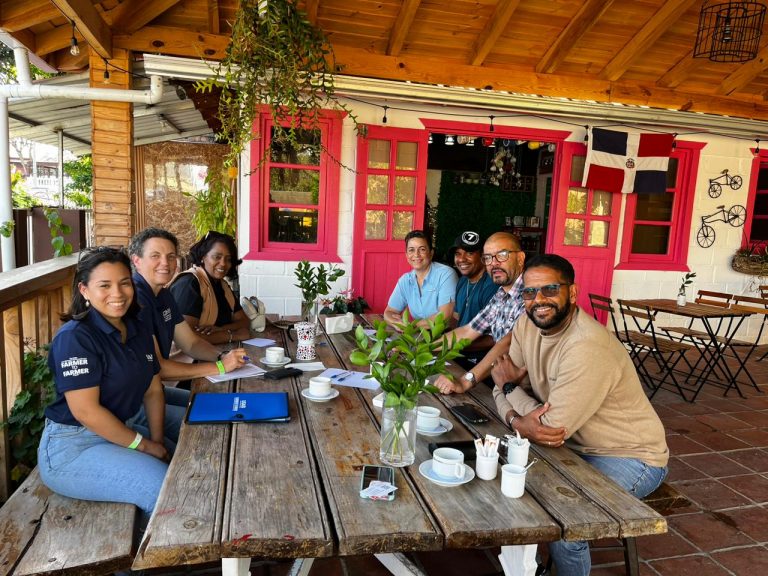 Group of volunteers and local agribusinesses meeting at a cafe