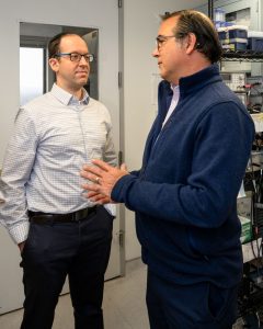 two men talking in lab