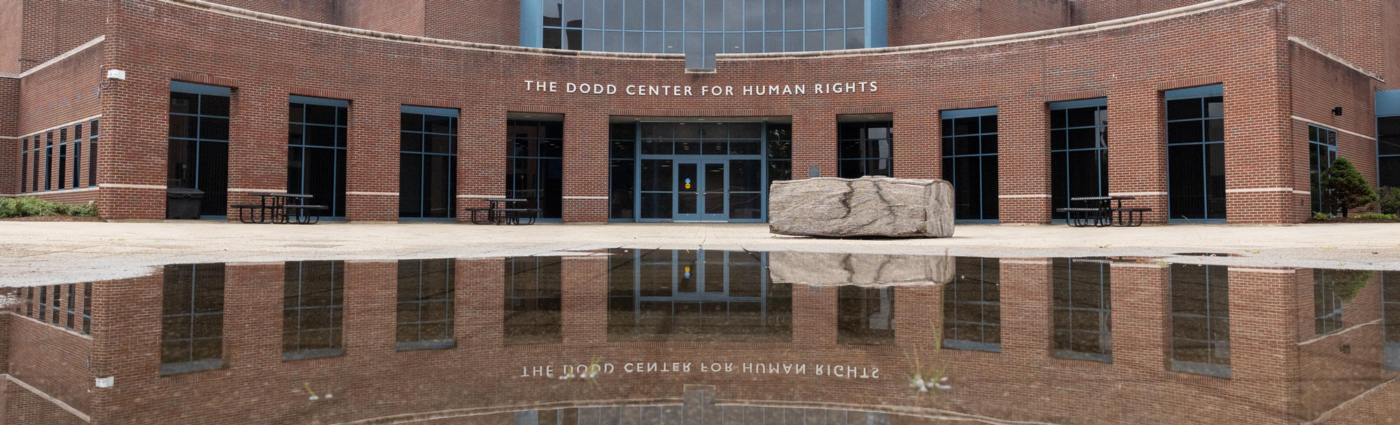 The Dodd Center for Human Rights and its reflection on a rainy day on the Storrs campus on Aug. 6, 2024.