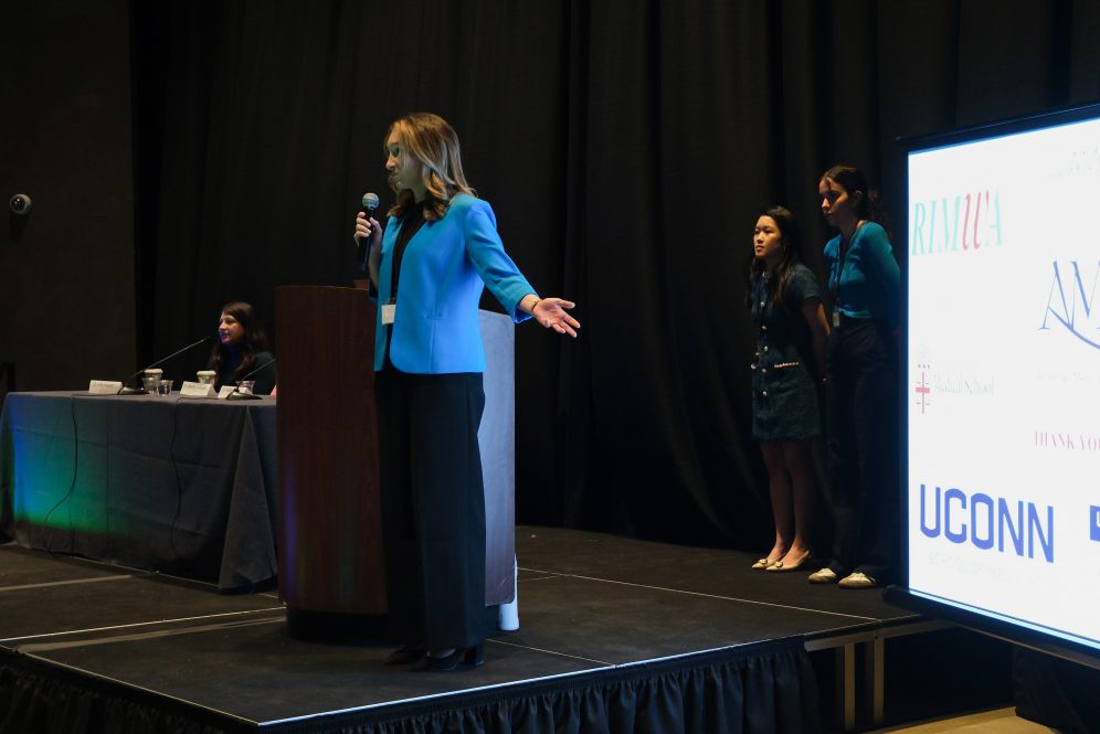 Third-year UConn medical student Angela McCarthy delivers her opening remarks at the American Medical Women’s Association (AMWA) Region 1 Conference in Boston. She is the first UConn medical student to be elected as AMWA Region 1 President (Photo by Olivia Kuk/Boston University medical student).