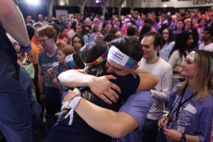 Two students embrace on the dance floor at HuskyTHON.