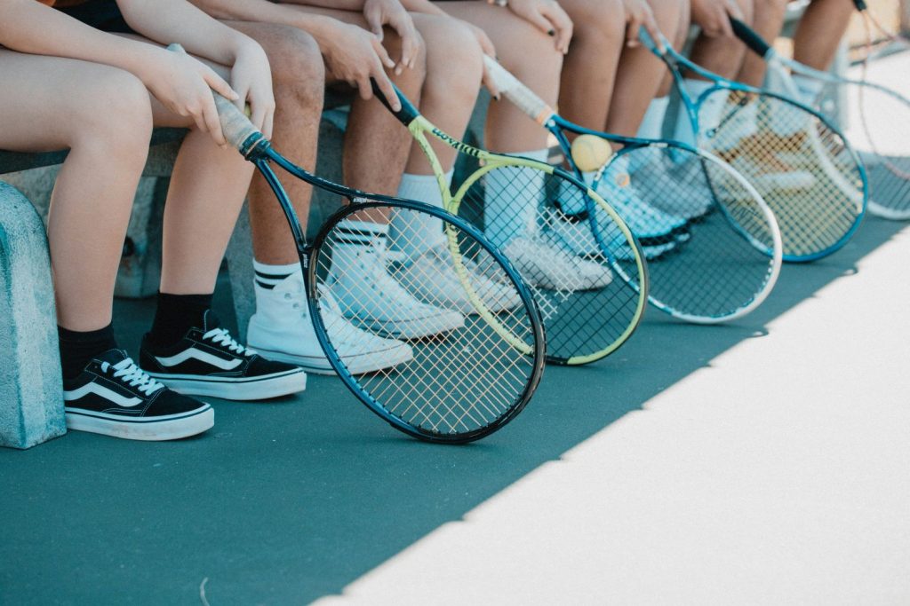 Students with tennis rackets