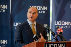 Eric Kruger, UConn Health vice president of facilities, development, and operations speaks at a podium