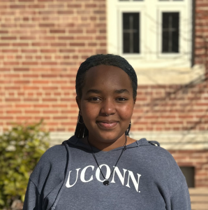 A portrait photo of UConn student Kanny Salike standing outside on campus.