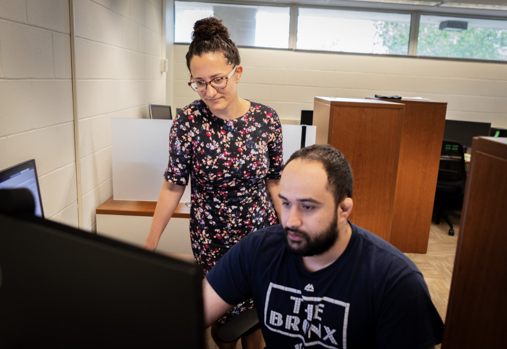 Anna Tarakanova, assistant professor of mechanical engineering and biomedical engineering, works with graduate student Mohammad Madani on a computer model inside the Pratt & Whitney Engineering Building. Tarakanova is the recipient of the American Society of Mechanical Engineers' 2024 Eshelby Mechanics Award for Young Faculty. (Christopher LaRosa/UConn Photo)