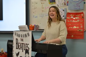 Giselle Ziegler plays a keyboard in her classroom.