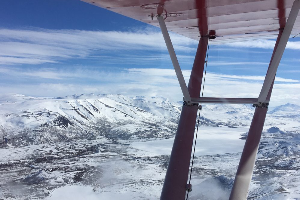 A wintry landscape seen from an airplane.