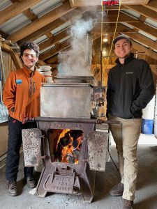 Students boiling maple sap for syrup