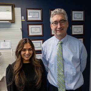 Portrait of Dr. Hetal Patel and Emmett Sullivan in pharmacy reception area