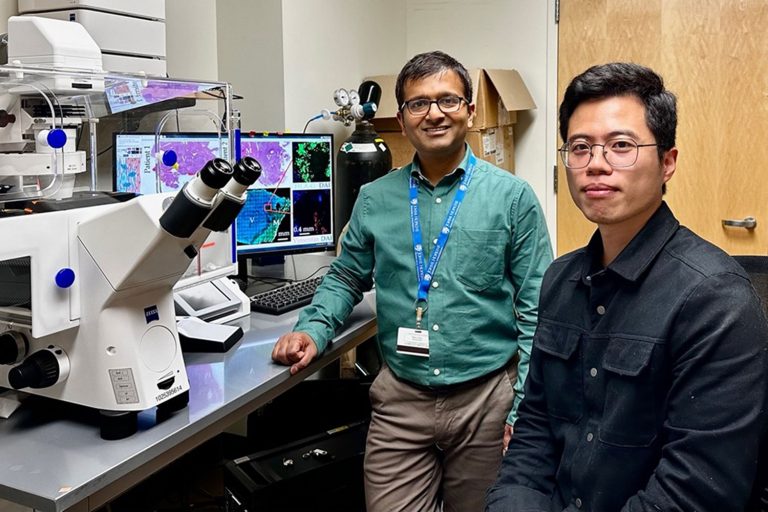 portrait of two men in research lab setting