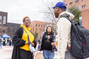 Ebonie Marie hadnign out affirmations to students on Fairfield Way