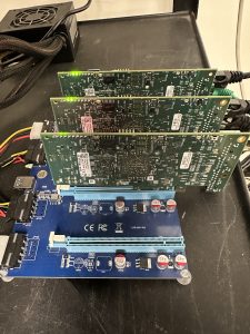A desk with three circuit boards displayed on a holder.