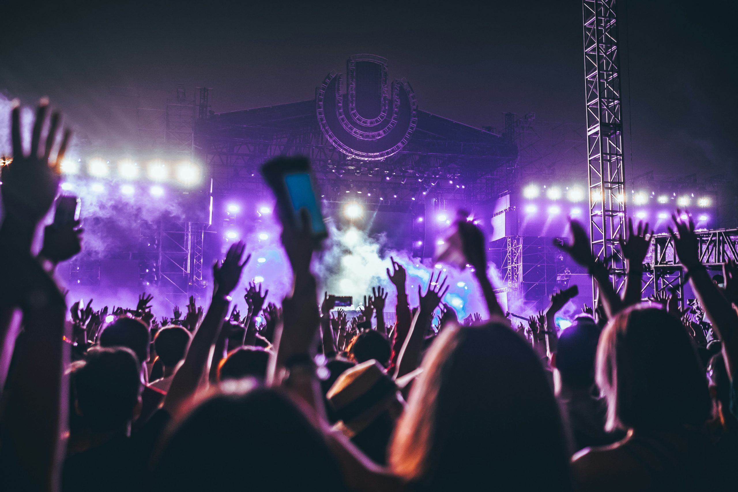 People raise their hands in the air at a rock concert