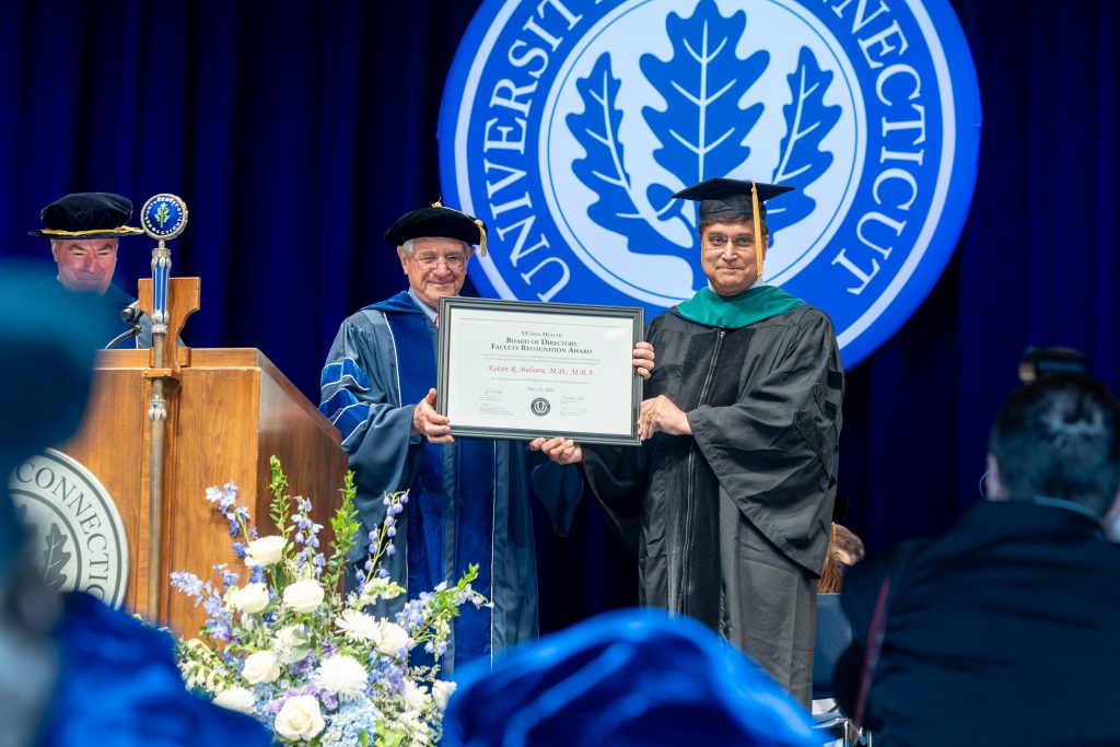 Dr. Ketan Bulsara accepts the 2025 Board of Directors Faculty Recognition Award during UConn Health's 54th Commencement on May 12, 2025. (Sydney Herdle/UConn Photo)