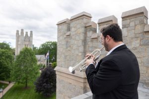 Heralder plays atop the library