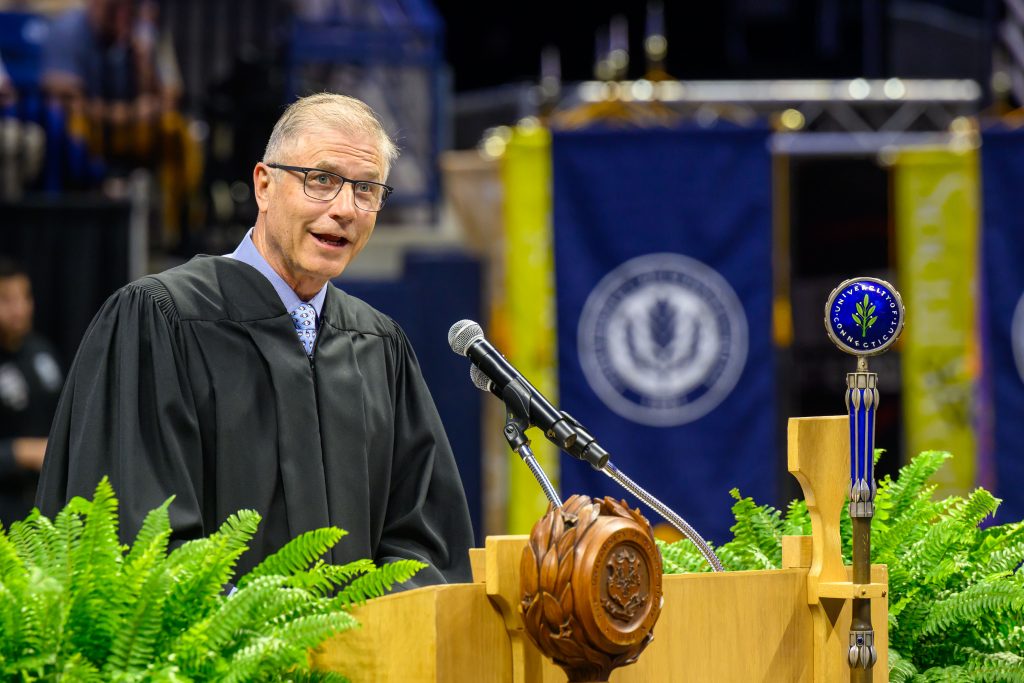 Richard Eldh Jr. '81 (BUS) gives the address at the School of Business Commencement ceremony at Gampel Pavilion on May 10, 2025. (Peter Morenus/UConn Photo)