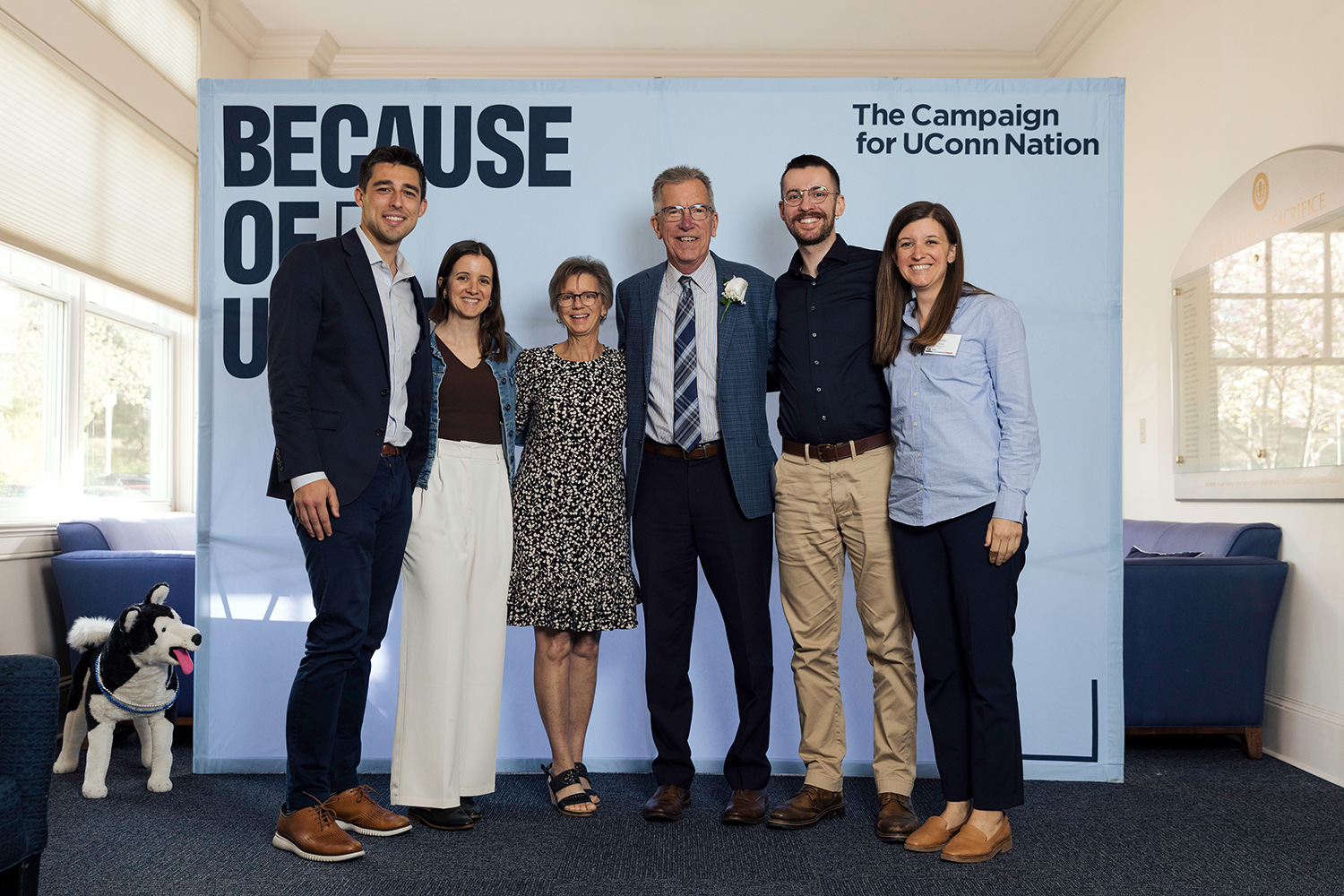 Mike Soltys ’81 (CLAS) and family stand in front of a backdrop that reads "The Campaign for UConn Nation."