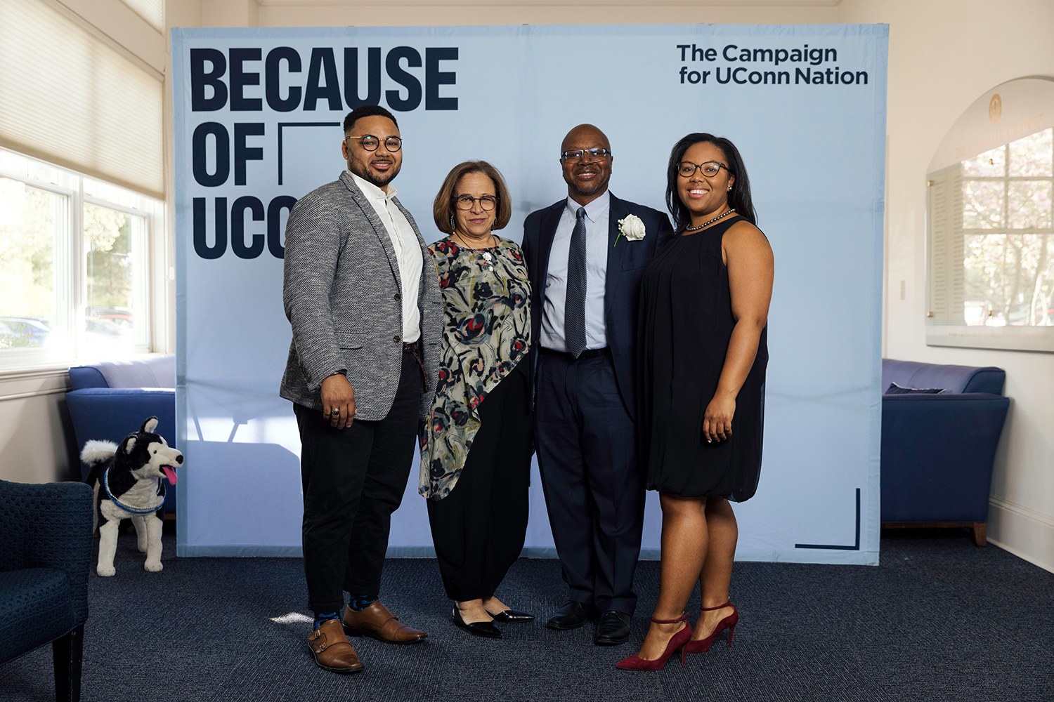 Bryan Pollard ’85 (CLAS) and family stand in front of a backdrop that reads "The Campaign for UConn Nation."