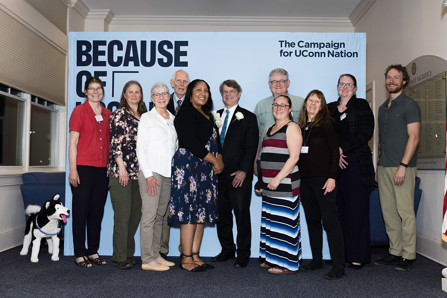 Tanisha Williams ’19 Ph.D. and family stand in front of a backdrop that reads "The Campaign for UConn Nation."