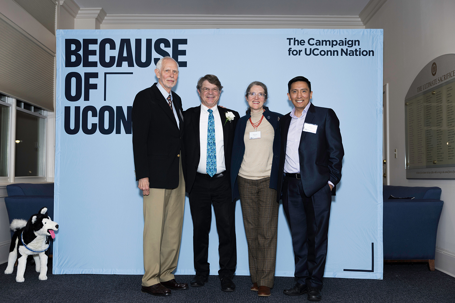 Richard Piacentini MS ’84 (CLAS) and family stand in front of a backdrop that reads "The Campaign for UConn Nation."