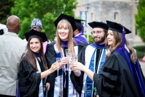 Graduates toast with champagne.