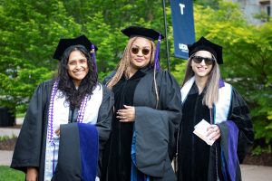 Three graduates pose.