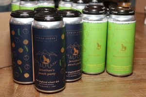 Cans of beer made by UConn students, called Jonathan's Peach Party and Courtside Cooler.