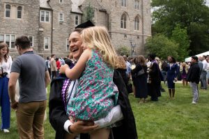 A graduate celebrates with her daughter.