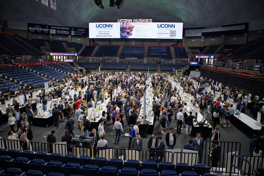 The floor of Gampel pavilion teaming with students, shot from the mezzanine above.