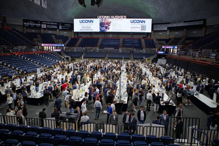 The floor of Gampel pavilion teaming with students, shot from the mezzanine above.