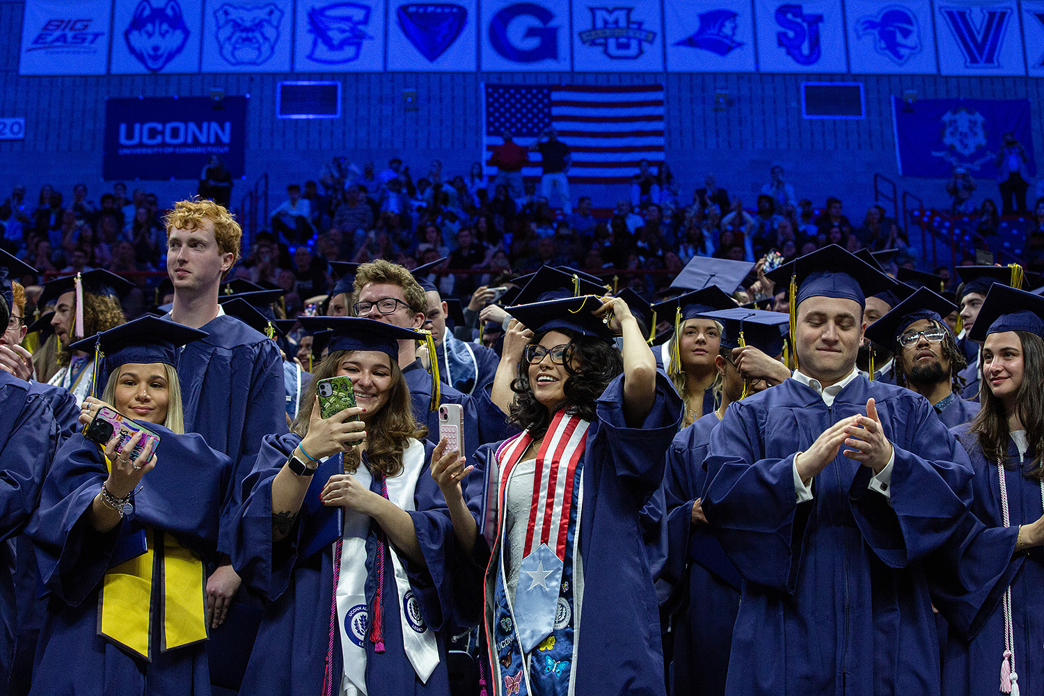 Graduates celebrate after turning their tassels at Gampel Pavilion.