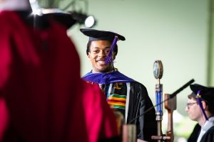 A graduate crosses the stage.
