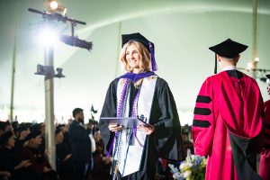 A graduate crosses the stage.