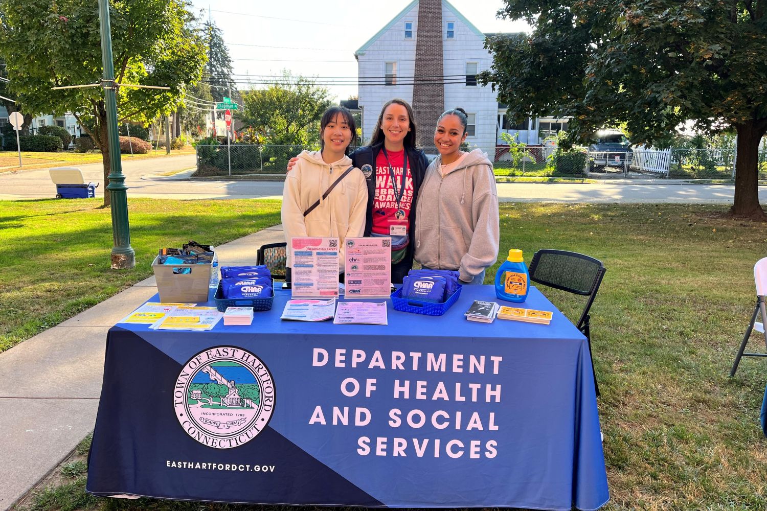 Students and a health coordinator at a table outside