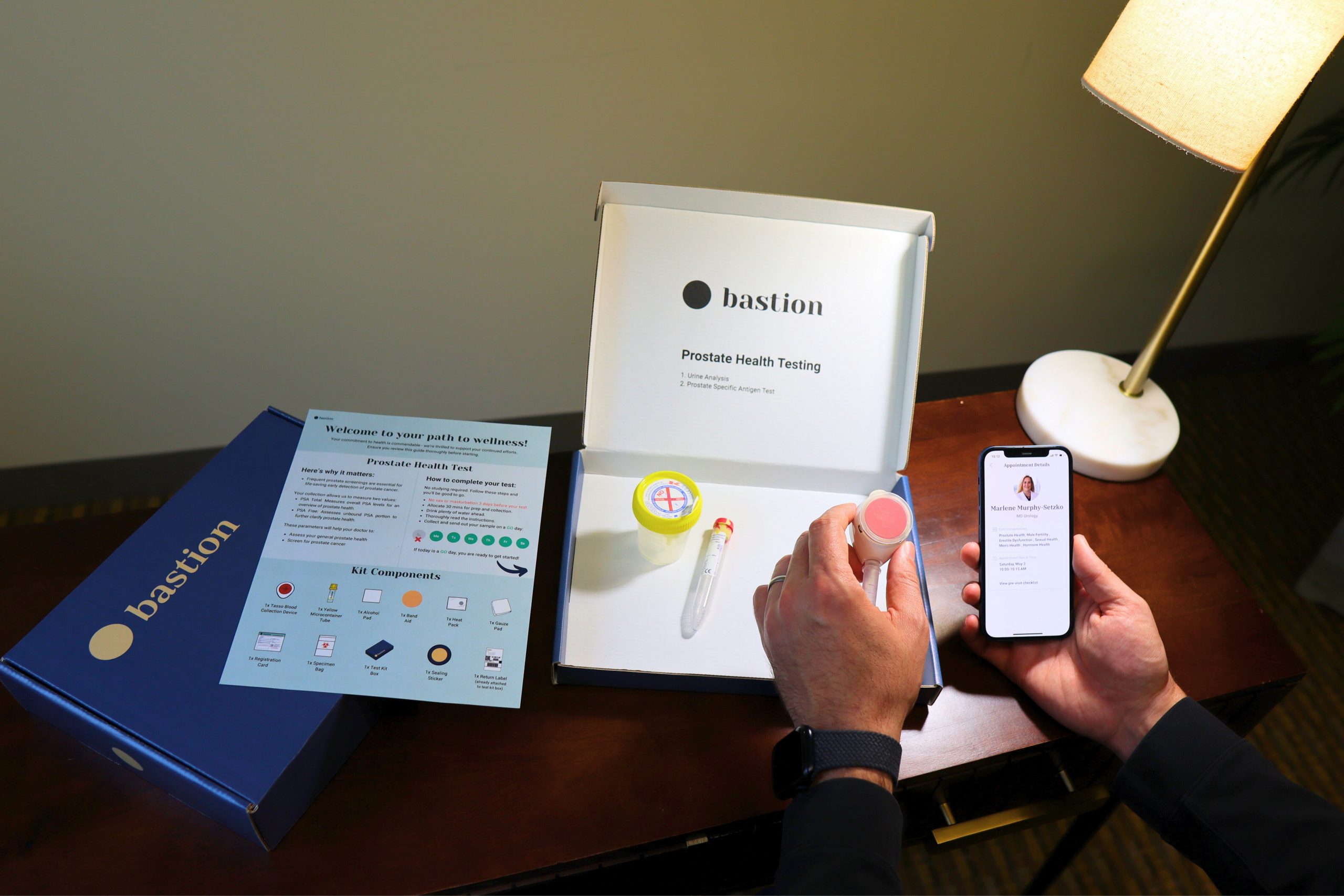 A man opens an in-home cancer testing kit on a desk.