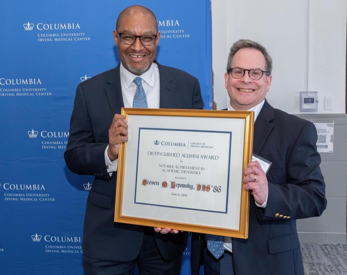 two men posing with award