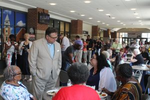 Waterbury Mayor Paul Pernerewski Jr. speaks with guests at OLLI's Juneteenth celebration