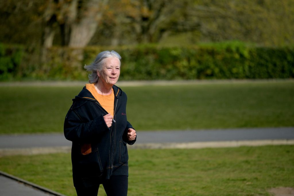 Older woman running outside