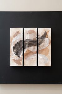 A black, brown, and white geometric painting.