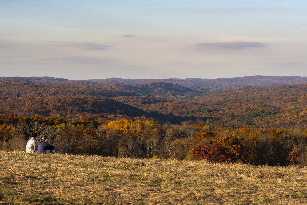 Two students on Horsebarn Hill during the golden hour