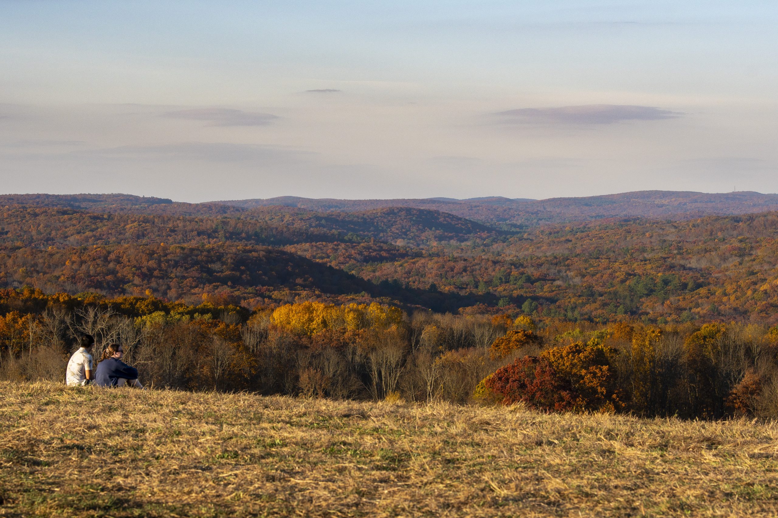 Two students on Horsebarn Hill during the golden hour
