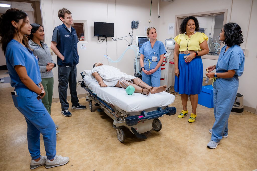 Cassandra Keola with fourth-year medical students in the Clinical Simulation Lab at UConn's medical school. 