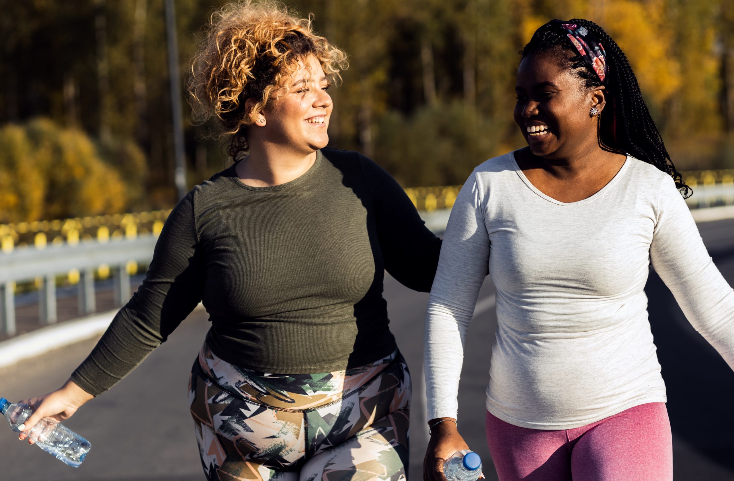 Two young plus size women walking together
