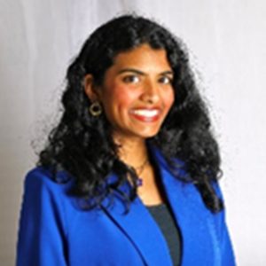Portrait of a woman with long hair wearing a blue blazer